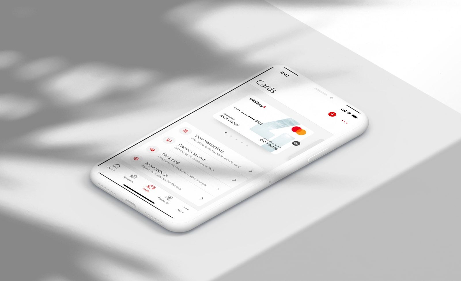 Smartphone lying on a table showing the UBS mobile banking app